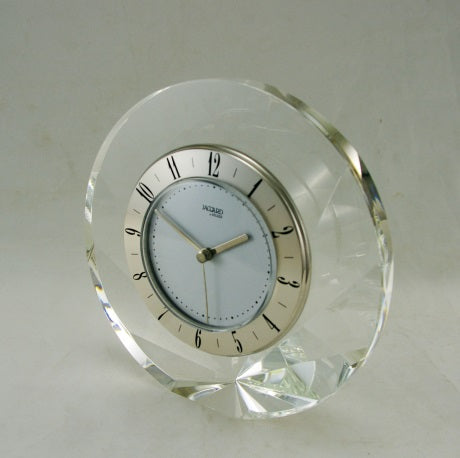 "Shell-Silver" Elegant Shell shaped desk clock made of real Crystal glass.Quartz clock with Silver finished brass timering and Arabic numerals. 145 dia x 45mm.1100 grams